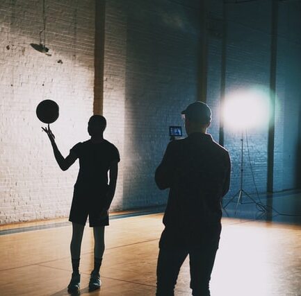 Person filming someone holding a basketball