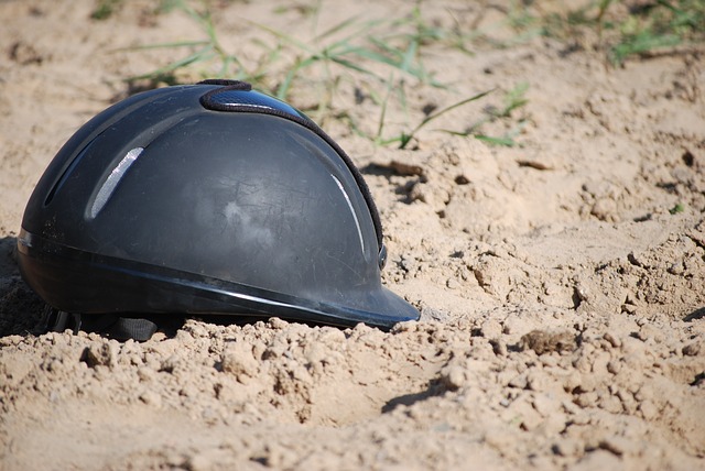 horseback riding helmet laying in the dirt